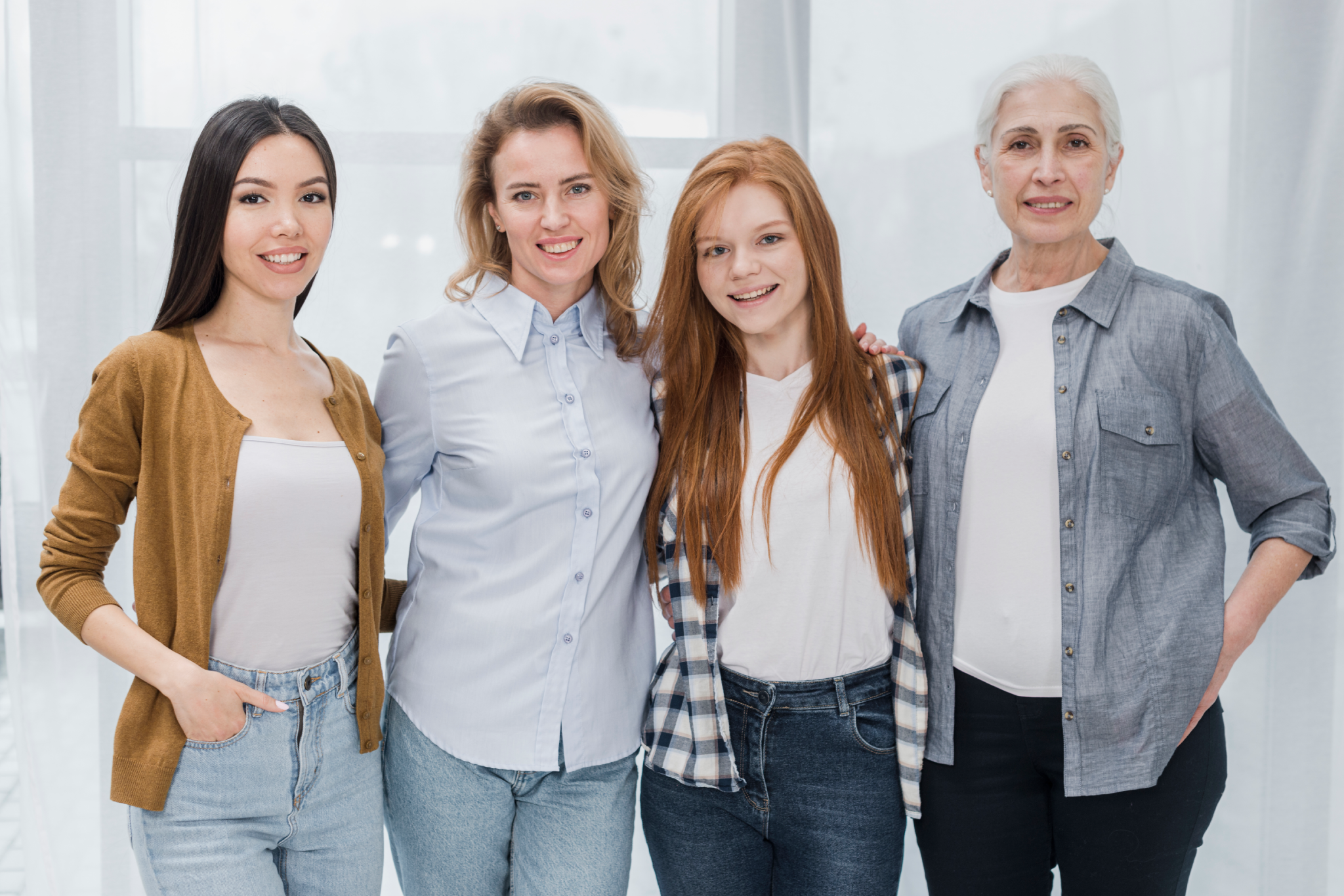 A diverse group of women standing together, smiling.