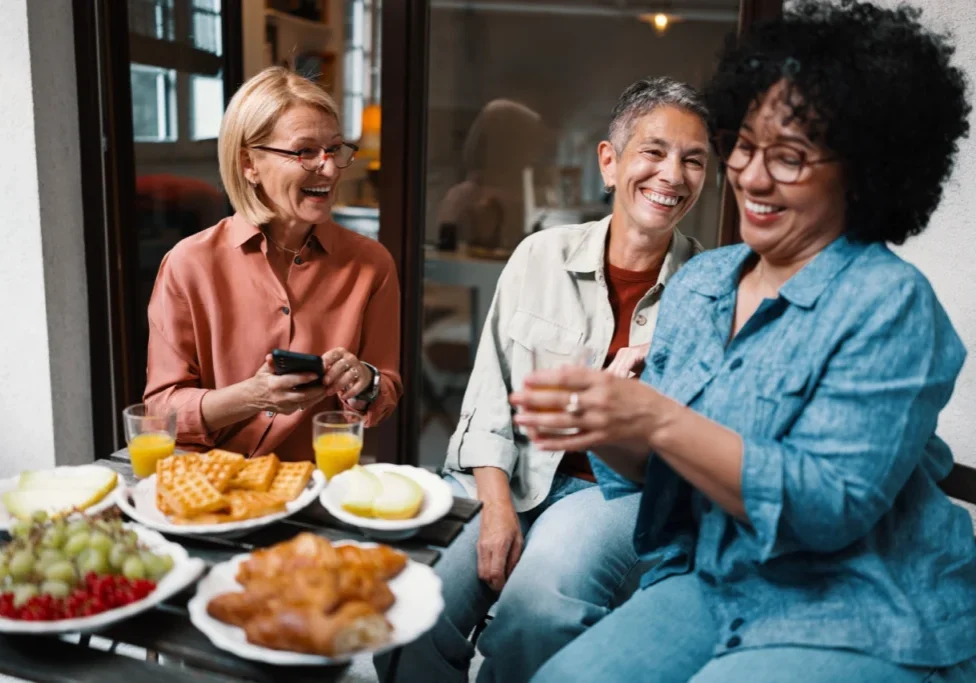 Friends laughing over brunch outdoors